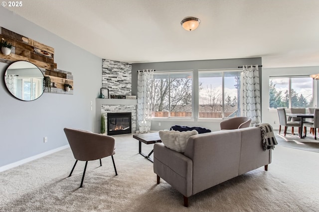 12998 SW Kostel Ln, Portland, OR 97224 - carpeted living room with a fireplace and baseboards