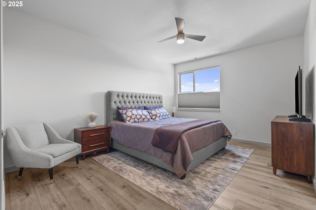 bedroom with light wood-style floors and a ceiling fan