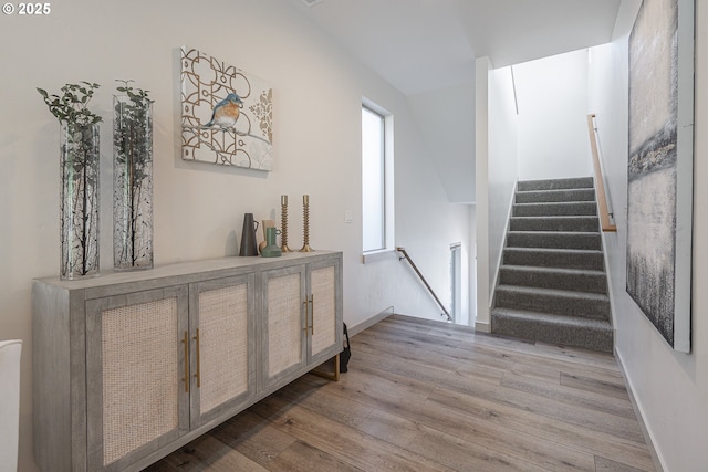 stairway with wood finished floors