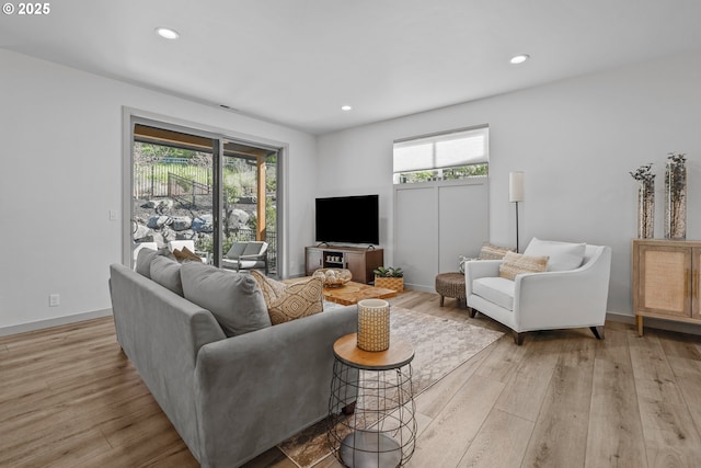 living area featuring recessed lighting and light wood-style floors