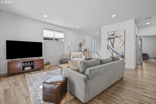 living area with recessed lighting, light wood finished floors, and visible vents