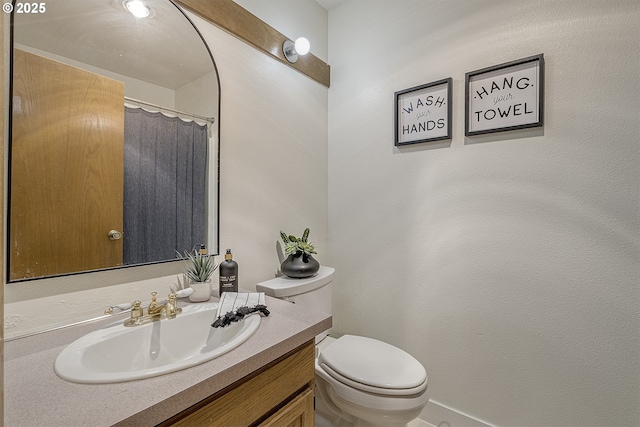 bathroom featuring toilet and vanity