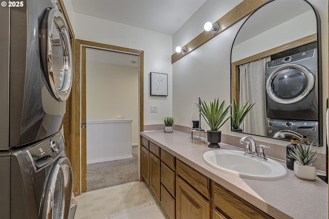 bathroom with vanity and stacked washer / drying machine