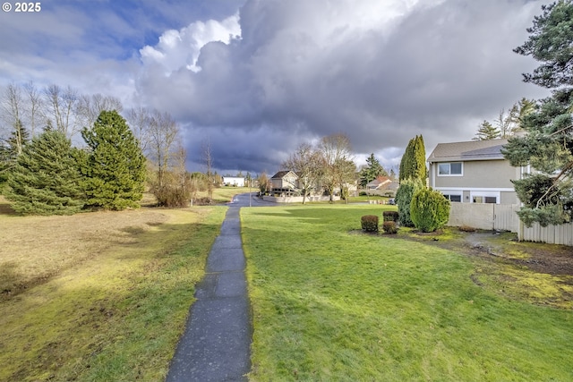 view of yard featuring fence and a residential view