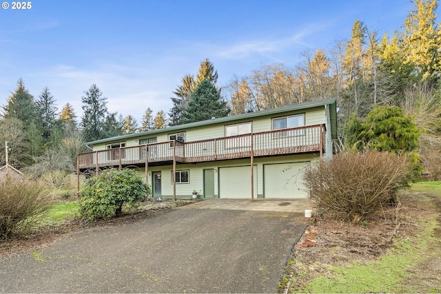 front facade with a deck and a garage