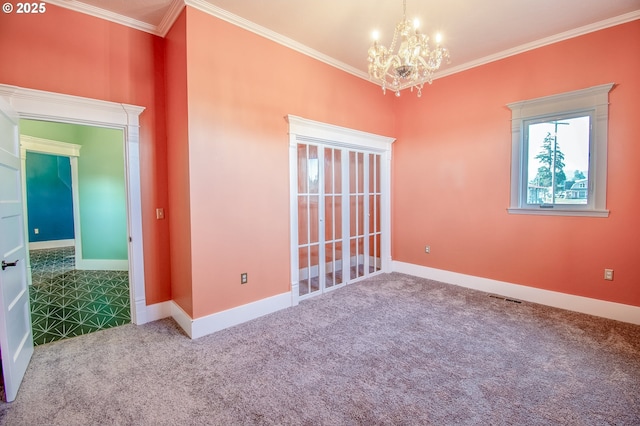 carpeted empty room featuring a notable chandelier and ornamental molding