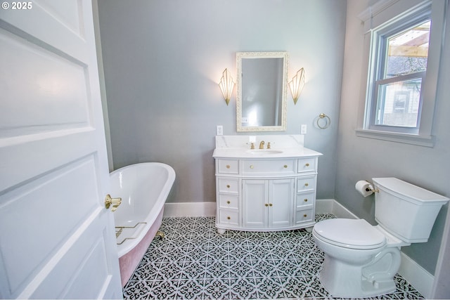 bathroom with toilet, a tub to relax in, tile patterned floors, and vanity