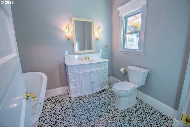 bathroom featuring vanity, toilet, a washtub, and tile patterned flooring