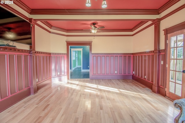 empty room with light hardwood / wood-style floors, crown molding, and ceiling fan