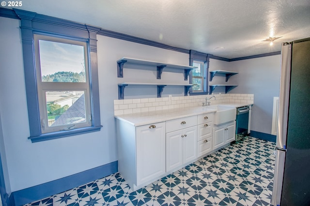 bathroom with vanity, crown molding, a textured ceiling, and tasteful backsplash