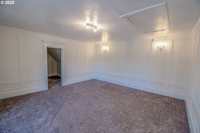 empty room featuring carpet, crown molding, and a textured ceiling