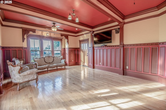 sitting room with ceiling fan, light hardwood / wood-style flooring, and crown molding