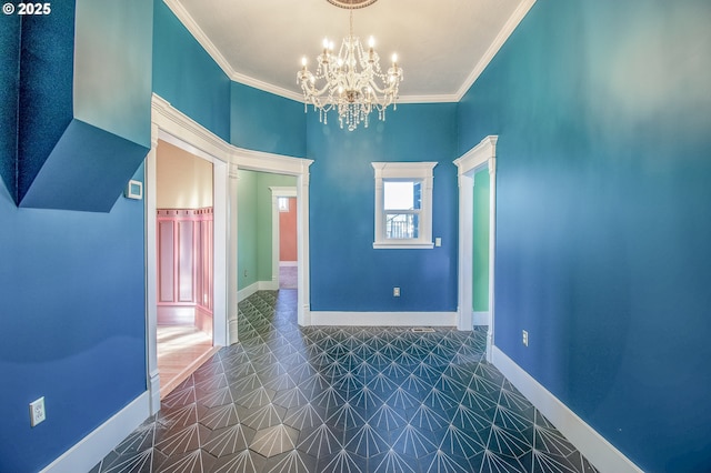 empty room with a chandelier and ornamental molding