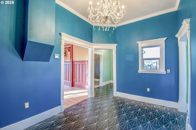 spare room with a chandelier and ornamental molding