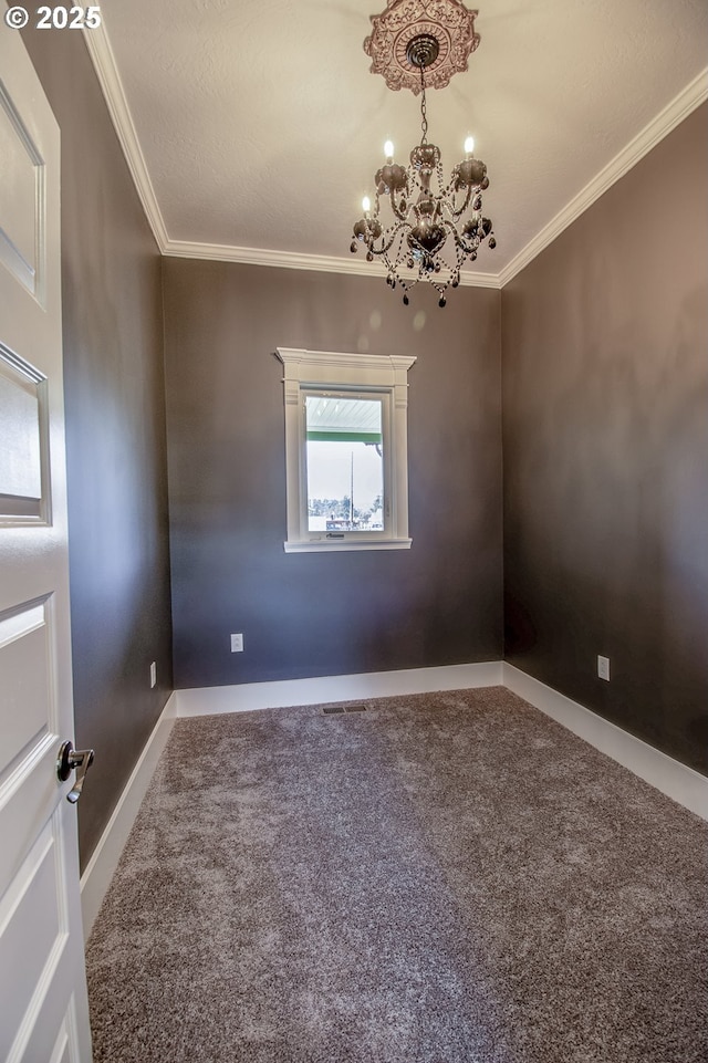 empty room with carpet floors, ornamental molding, and a notable chandelier