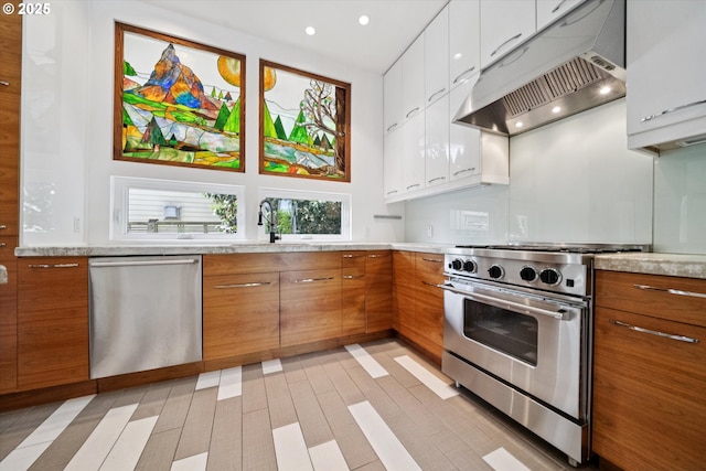6035 NE 9th Ave, Portland, OR 97211 - kitchen featuring appliances with stainless steel finishes, custom range hood, light countertops, white cabinets, and brown cabinetry