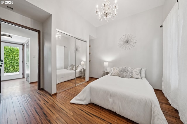 6035 NE 9th Ave, Portland, OR 97211 - bedroom featuring a chandelier, a closet, and wood finished floors