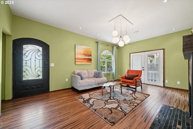 6035 NE 9th Ave, Portland, OR 97211 - living area with wood-type flooring, arched walkways, a chandelier, and recessed lighting
