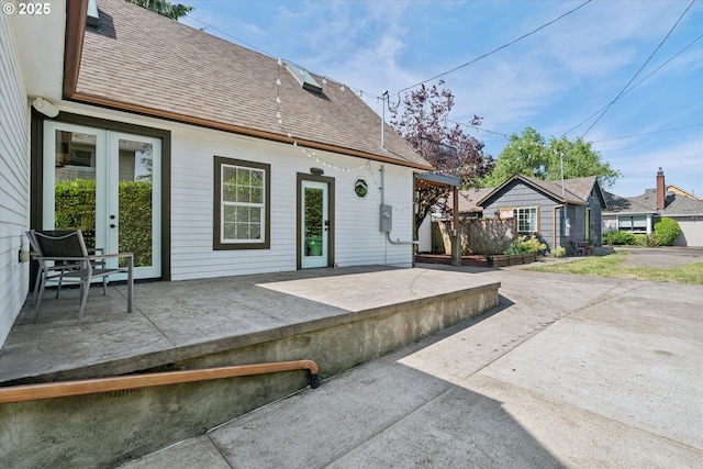6035 NE 9th Ave, Portland, OR 97211 - rear view of property with roof with shingles and a patio area