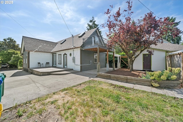 6035 NE 9th Ave, Portland, OR 97211 - rear view of house with a patio, roof with shingles, a storage shed, and a balcony