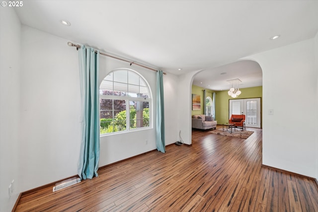 6035 NE 9th Ave, Portland, OR 97211 - unfurnished room featuring arched walkways, hardwood / wood-style flooring, recessed lighting, and a chandelier
