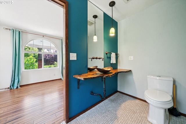 6035 NE 9th Ave, Portland, OR 97211 - bathroom with high vaulted ceiling and wood finished floors
