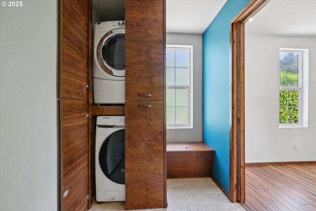 6035 NE 9th Ave, Portland, OR 97211 - washroom with stacked washing machine and dryer and baseboards