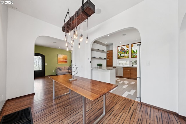 6035 NE 9th Ave, Portland, OR 97211 - unfurnished dining area with arched walkways, light wood finished floors, and recessed lighting