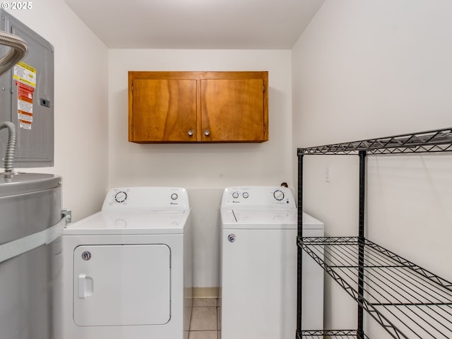 laundry room featuring cabinet space, washer and clothes dryer, water heater, light tile patterned floors, and electric panel