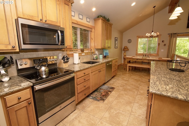 kitchen with backsplash, light tile patterned floors, appliances with stainless steel finishes, and a sink