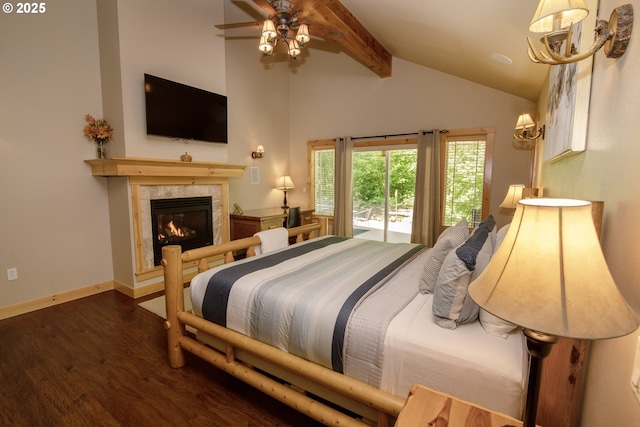 bedroom with ceiling fan, wood finished floors, a tile fireplace, baseboards, and lofted ceiling with beams