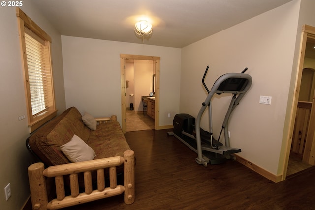 exercise area with baseboards and wood finished floors