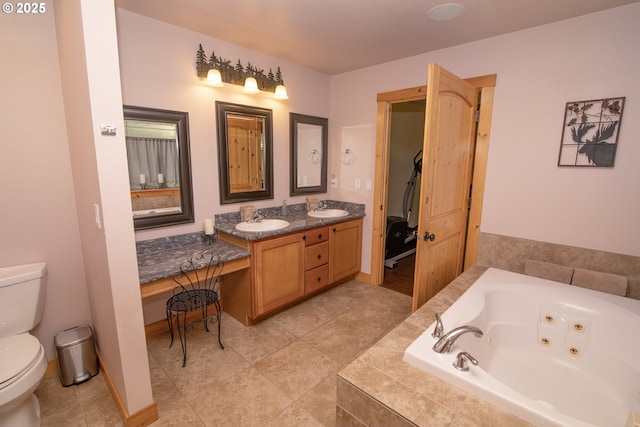 full bath with a whirlpool tub, a sink, double vanity, and toilet
