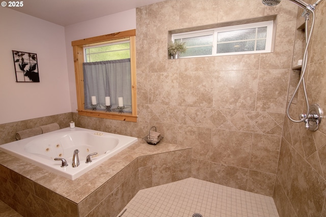 bathroom with a tub with jets and tiled shower