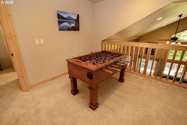 rec room featuring carpet floors, a ceiling fan, baseboards, and vaulted ceiling