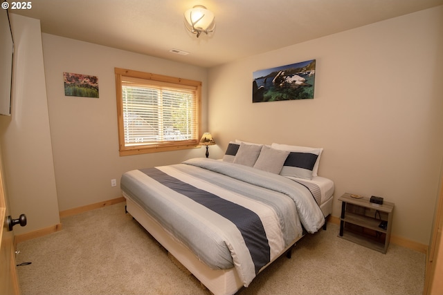 carpeted bedroom featuring baseboards and visible vents