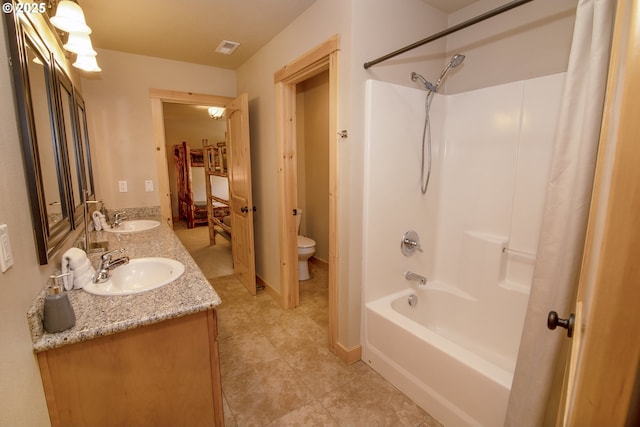 full bath featuring visible vents, a sink, double vanity, and toilet