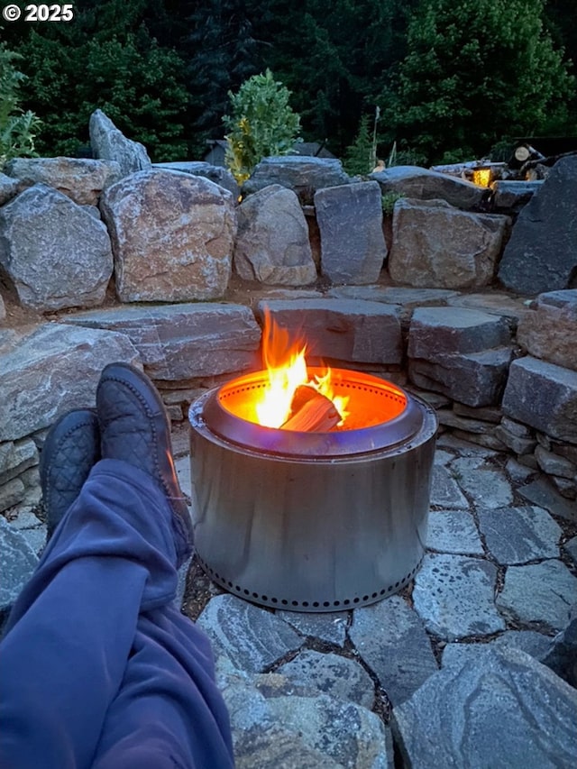 exterior details featuring an outdoor fire pit