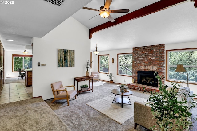 carpeted living room featuring lofted ceiling with beams, ceiling fan, a healthy amount of sunlight, and a fireplace
