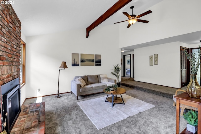 living room featuring a ceiling fan, a brick fireplace, beam ceiling, baseboards, and carpet flooring
