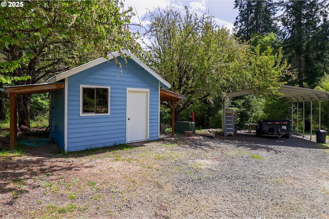 view of shed featuring driveway and a carport