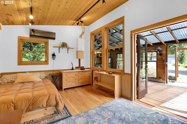 bedroom featuring light wood finished floors, rail lighting, access to exterior, wooden ceiling, and a wall mounted AC