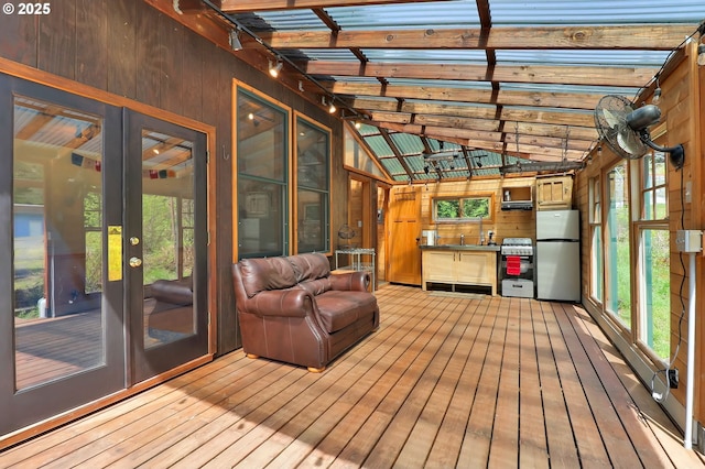 unfurnished sunroom with beam ceiling and french doors