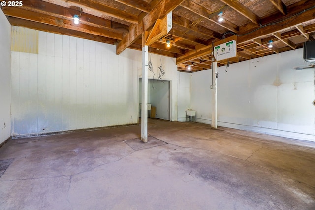 basement featuring wooden walls
