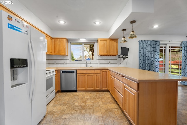 1604 NE 153rd Pl, Portland, OR 97230 - kitchen featuring white appliances, a peninsula, light countertops, tasteful backsplash, and hanging light fixtures