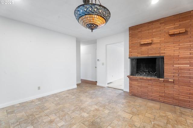 1604 NE 153rd Pl, Portland, OR 97230 - unfurnished living room with stone finish floors, a brick fireplace, and recessed lighting