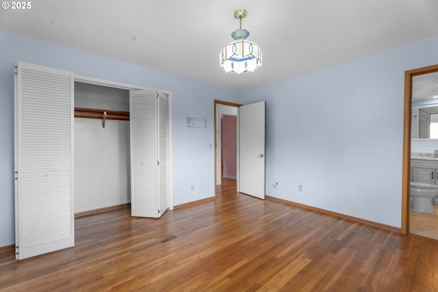 1604 NE 153rd Pl, Portland, OR 97230 - unfurnished bedroom with wood finished floors, a closet, a chandelier, and ensuite bath