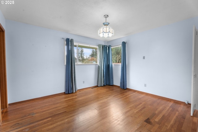 1604 NE 153rd Pl, Portland, OR 97230 - unfurnished room with wood finished floors and a chandelier