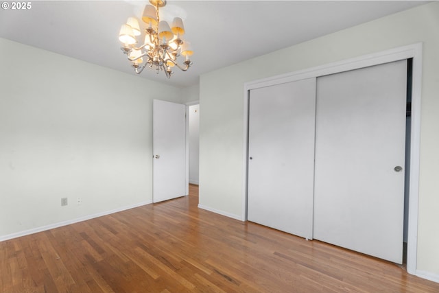1604 NE 153rd Pl, Portland, OR 97230 - unfurnished bedroom featuring a chandelier, wood finished floors, and a closet