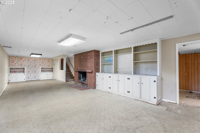 1604 NE 153rd Pl, Portland, OR 97230 - unfurnished living room featuring wallpapered walls, a brick fireplace, and light colored carpet